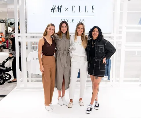 Four women standing together at the H&M x ELLE Style Lab event, smiling at the camera in trendy outfits.