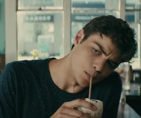 Peter Kavinsky drinking a milkshake in a cafe from "To All the Boys I've Loved Before".