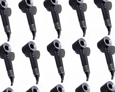 "Image showing multiple black hairdryers arranged in a grid pattern on a white background."