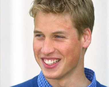 A young man with a smile and a faint scar on his forehead, wearing a blue shirt and sweater, from prince-william-harry-potter-scar-18402.