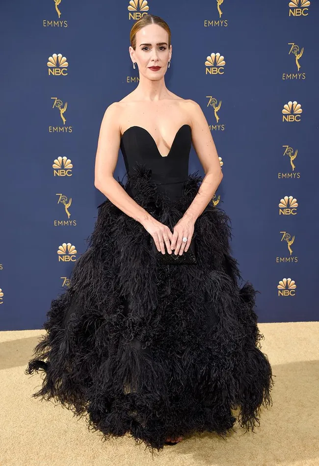 Person in a black gown at the 70th Emmy Awards, posing on the red carpet with an NBC background.
