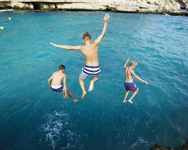 Boys jumping off a cliff.