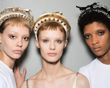 "Three models wearing embellished headbands with neutral makeup against a plain background."