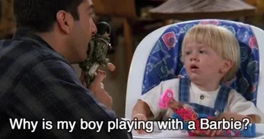 Ross from Friends disapproves as his young son Ben plays with a Barbie doll.