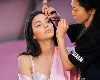 Makeup artist applies makeup to woman's eyelashes, beauty trend, 2018.