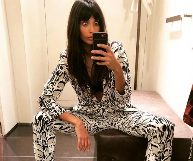 Jameela Jamil takes a selfie in a dressing room, wearing a white and black patterned outfit, with her eyes wide open.
