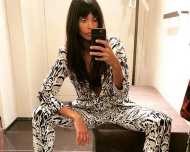 Jameela Jamil takes a selfie in a dressing room, wearing a white and black patterned outfit, with her eyes wide open.