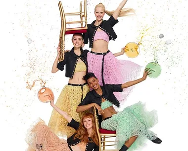 Four women in colorful skirts joyfully pose with Chanel Chance Eau Tendre perfume bottles, exuding playful energy.