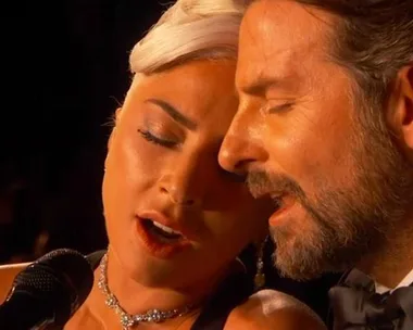 Lady Gaga and Bradley Cooper perform "Shallow" at the 2019 Oscars, close together and singing passionately.