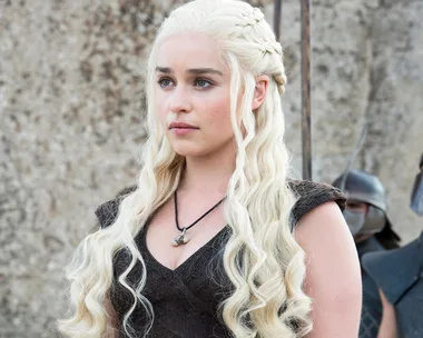 Daenerys Targaryen with long blonde hair, standing in front of Unsullied soldiers, from Game of Thrones scene.