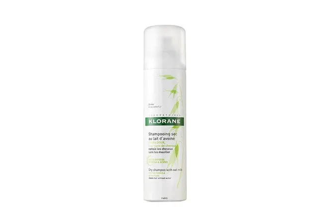 Klorane Dry Shampoo with oat milk in a white spray can, featuring green leaf design.
