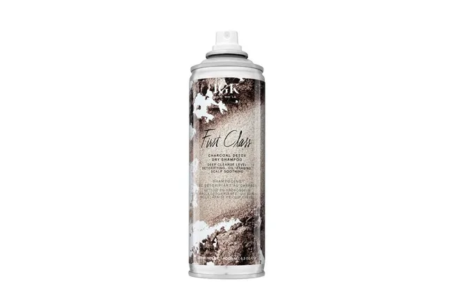 Dry shampoo can labeled "IGK First Class Charcoal Detox," with a brown and white design.