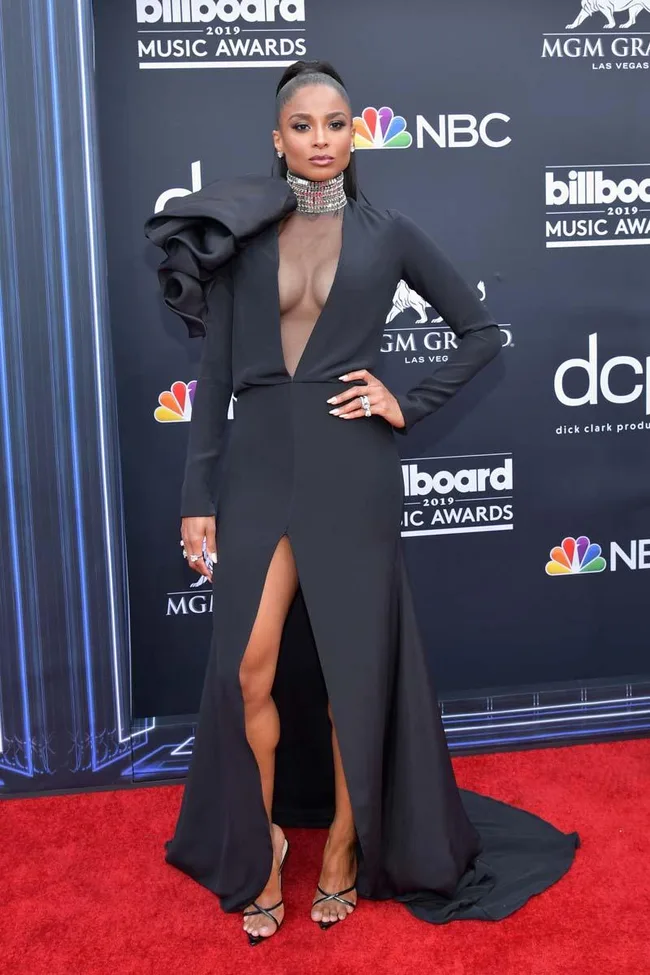 Ciara at the 2019 Billboard Music Awards in a black gown with a sheer panel and high slit on the red carpet.