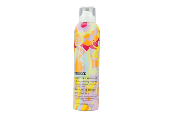 Amika Perk Up Dry Shampoo bottle with colorful design and spray nozzle on top.