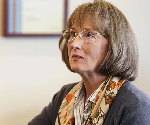 A woman with glasses and a floral scarf looks serious in a scene from "Big Little Lies" Season 2.