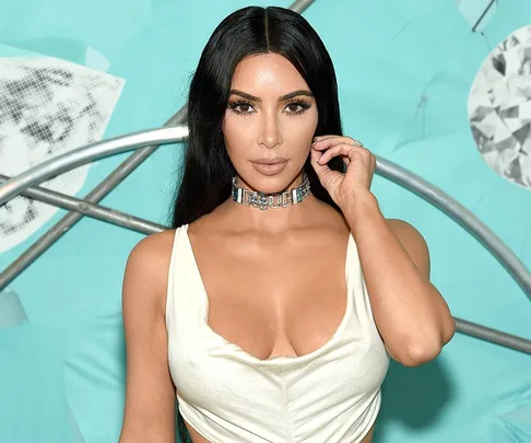 Kim Kardashian attends a Tiffany & Co. party wearing a white dress.