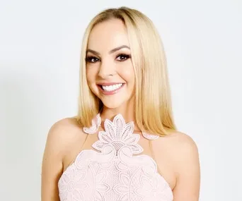 Smiling woman in a white lace dress from "Bachelorette Australia 2019."