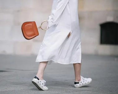 White sneakers and skirt street style.