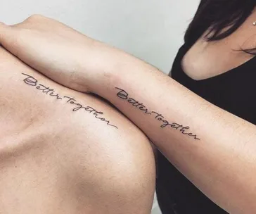 Two people with matching "Better together" tattoos on their forearms.