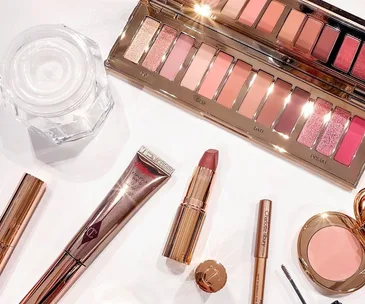 Charlotte Tilbury Pillow Talk makeup range with palette, lipstick, and more on a white background.