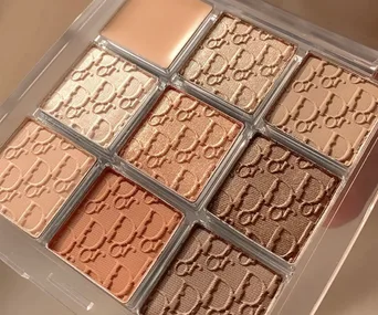 Warm-toned eyeshadow palette with embossed "Dior" logo on nine shades.