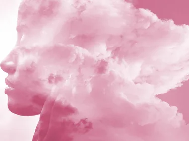 Silhouette of a person's profile merged with pink clouds, symbolizing thoughts or emotions.