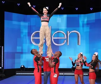 Kendall Jenner being lifted by Navarro College cheerleaders on "The Ellen Show" stage.