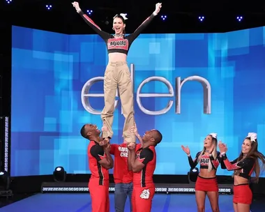 Kendall Jenner being lifted by Navarro College cheerleaders on "The Ellen Show" stage.