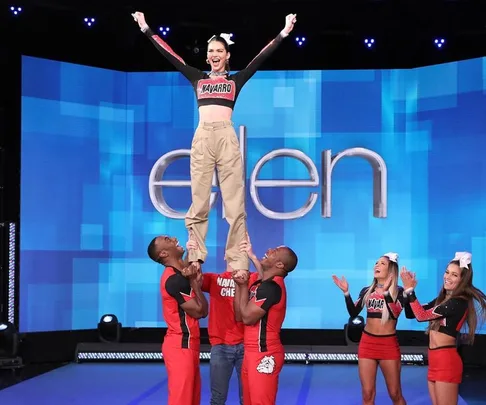 Kendall Jenner being lifted by Navarro College cheerleaders on "The Ellen Show" stage.