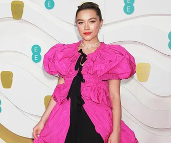 Florence Pugh in a bright pink gown on the BAFTAs 2020 red carpet.