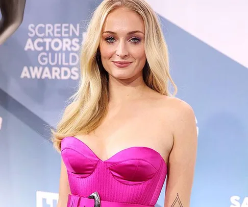 A woman in a pink strapless dress at the Screen Actors Guild Awards, smiling at the camera.