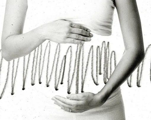 A woman's hands cradle her stomach, with abstract wavy lines in the background, symbolizing emotional turmoil.