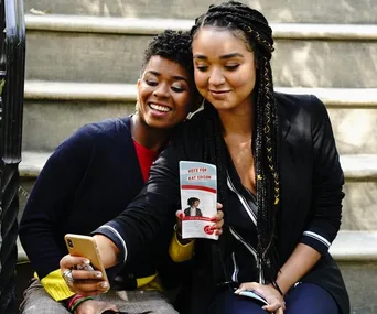 Two people taking a selfie on steps, holding a flyer that says "Vote for Kat Edison."