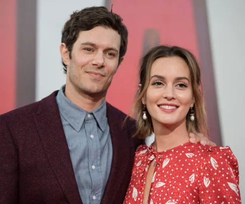 Smiling couple posing at an event, wearing formal attire.