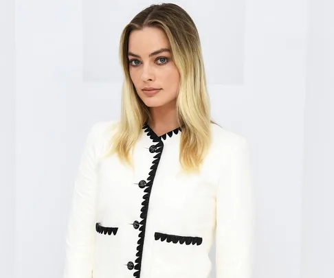 A person in a white Chanel outfit with black accents at Paris Fashion Week 2020.