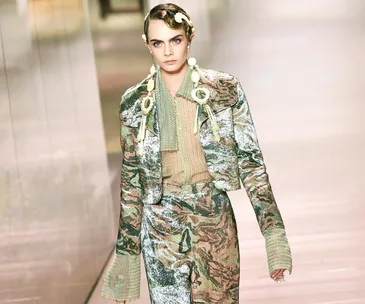 Model in shimmering floral suit with statement rings and sleek hairstyle at Fendi Spring 2021 Couture show.