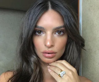 Woman displaying a unique engagement ring with two large stones.