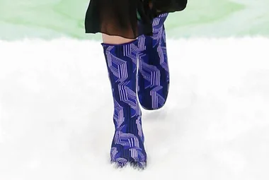 Blue patterned Prada AW21 boots on white runway.