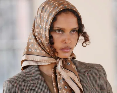 Model wearing a patterned headscarf and plaid blazer at Milan Fashion Week Autumn/Winter 2021.