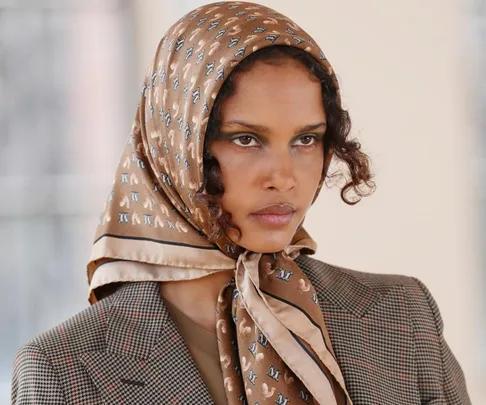 Model wearing a patterned headscarf and plaid blazer at Milan Fashion Week Autumn/Winter 2021.