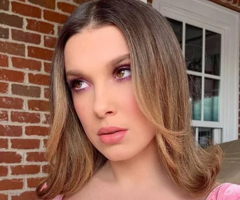 Millie Bobby Brown with a flip hairstyle.