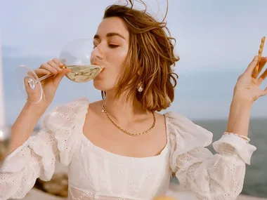 Carmen Grace Hamilton drinking white wine