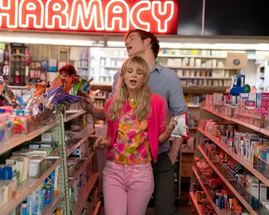 Carey Mulligan in a colorful outfit walks through a pharmacy aisle in "Promising Young Woman."