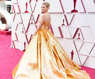 Carey Mulligan in a shimmering gold gown at the Oscars 2021 red carpet.