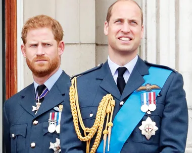 Two men in military uniforms, standing side by side, adorned with various medals and insignias.