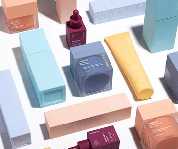 A variety of colorful skincare product boxes and bottles arranged on a white background.