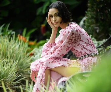 Girl with bob wearing a pink dress in a garden