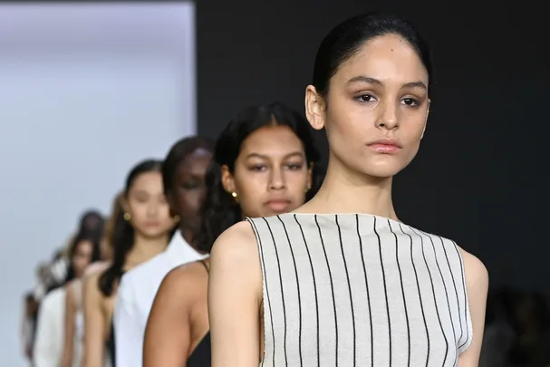 Models walking the runway at Australian Fashion Week 2021, wearing sleek, minimalistic outfits.