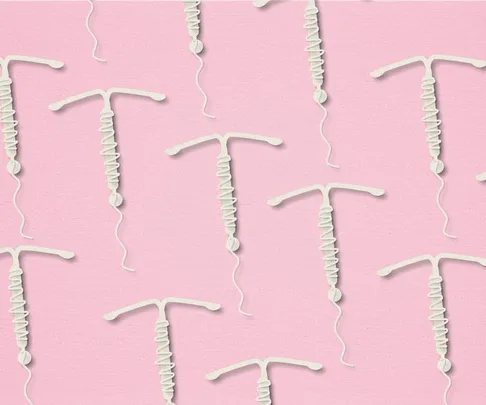 Pattern of white IUD contraceptives on a pink background.