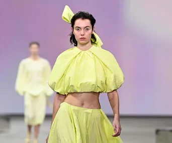 Model in a lemon yellow outfit walking the runway at Australian Fashion Week 2021.